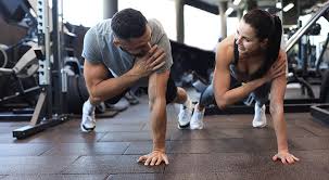 Sculpting Sleek Arms: The Essential Role of Cardio in Toning Without Bulking Up 1 Image of man and woman doing Cardio Chelmsford to tone their arms.